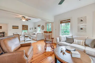 a living room with a couch and a table at Historic Farmhouse Near Mountains and Colleges! in Westfield