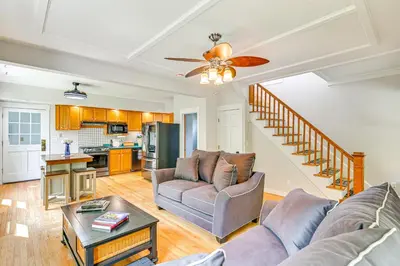 a living room with a couch and a table at Saratoga Springs Home with Hot Tub Walk to Downtown in Saratoga Springs