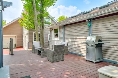 a patio with chairs and a grill on a house at Saratoga Springs Home with Hot Tub Walk to Downtown in Saratoga Springs