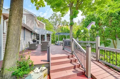 a wooden deck with a fence and a tree at Saratoga Springs Home with Hot Tub Walk to Downtown in Saratoga Springs