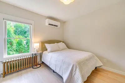 a bedroom with a bed and a window at Saratoga Springs Home with Hot Tub Walk to Downtown in Saratoga Springs