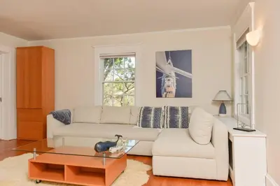 a living room with a white couch and a coffee table at Luxury 5 Star Home with Amazing Water Views in Mamaroneck