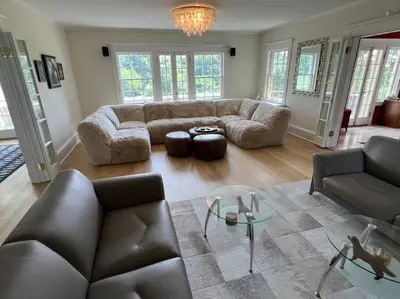 a living room with a couch and a table at Luxury 5 Star Home with Amazing Water Views in Mamaroneck