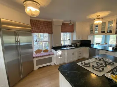 a kitchen with a refrigerator and a counter top at Luxury 5 Star Home with Amazing Water Views in Mamaroneck