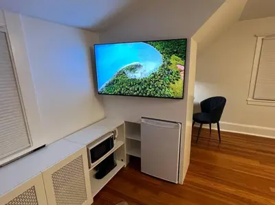 a living room with a flat screen tv on a wall at Luxury 5 Star Home with Amazing Water Views in Mamaroneck