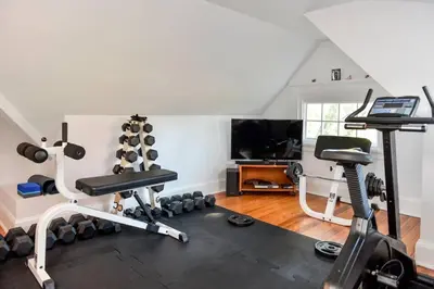a room with a gym with a treadmill and weights at Luxury 5 Star Home with Amazing Water Views in Mamaroneck