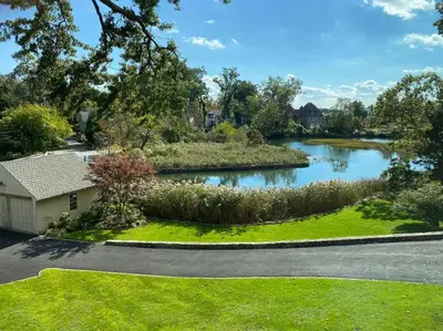 a house with a garden with a river at Luxury 5 Star Home with Amazing Water Views in Mamaroneck