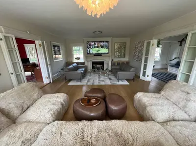 a living room with two couches and a tv at Luxury 5 Star Home with Amazing Water Views in Mamaroneck