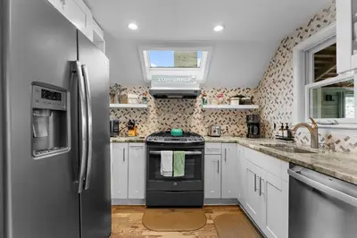 a kitchen with a refrigerator and a stove at Charming Fairfield Cottage By The Sea in Fairfield