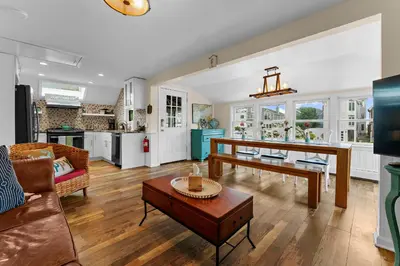 a living room with a couch and a table at Charming Fairfield Cottage By The Sea in Fairfield