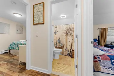 a bathroom with a bed and a toilet in a room at Charming Fairfield Cottage By The Sea in Fairfield