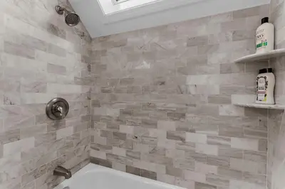 a bathroom with a shower with a toilet in it at Charming Fairfield Cottage By The Sea in Fairfield
