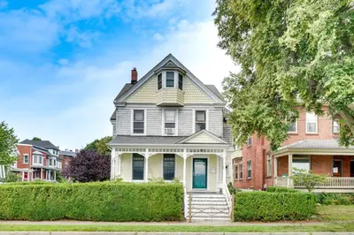 a house in a residential neighborhood with bushes at Walk to Hudson River Pet-Friendly Home with Views! in Newburgh