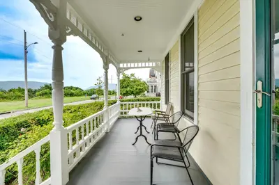 a porch with chairs and a table on a house at Walk to Hudson River Pet-Friendly Home with Views! in Newburgh