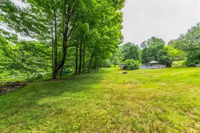 an open field with trees and a gazebo at Bear Pass - Mountain View home in Sunderland
