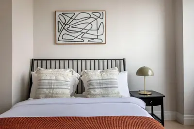 a bedroom with a bed and a picture on the wall at Blueground UES pool gym nr central park NYC-1293 in New York
