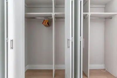 a closet with white walls and white doors at Blueground UES pool gym nr central park NYC-1293 in New York