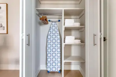 a tie is hanging in a closet at Blueground UES pool gym nr central park NYC-1293 in New York
