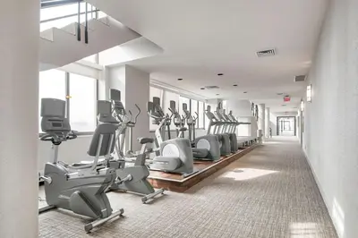 a gym with treadmills and elliptical machines at Blueground UES pool gym nr central park NYC-1293 in New York