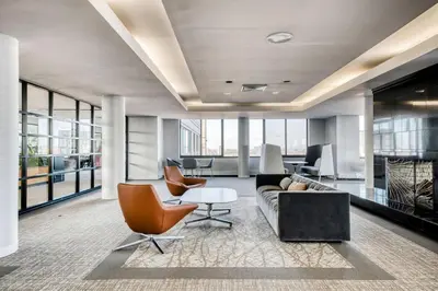 an office with a couch and chairs and a table at Blueground UES pool gym nr central park NYC-1293 in New York