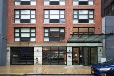 a brick building with a parking lot in front of it at LES 1br w gym doorman wd nr park NYC-1314 in New York