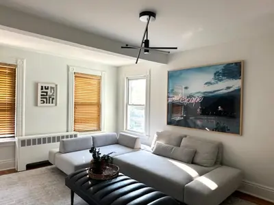 a living room with a couch and a ceiling fan at Sweet Escape, 2BR apt in BEACH community, Only 1 hr to NYC! in Norwalk