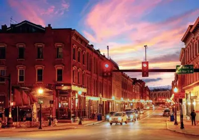 a city street at night with a red traffic light at Sweet Escape, 2BR apt in BEACH community, Only 1 hr to NYC! in Norwalk