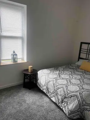 a bedroom with a bed next to a window at Renovated 3 bedroom for Professionals in Albany