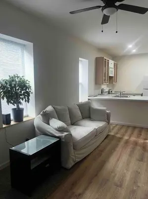 a living room with a couch and a kitchen at Renovated 3 bedroom for Professionals in Albany