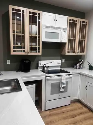 a kitchen with white cabinets and a stove top oven at Renovated 3 bedroom for Professionals in Albany
