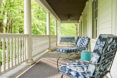 two chairs on the porch of a house at Ulster County Farmhouse Near Waterfalls and Winery! in Pine Bush