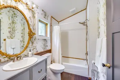 a bathroom with a sink toilet and a mirror at Grill and Fire Pit Eclectic Ulster County Cabin in Pine Bush