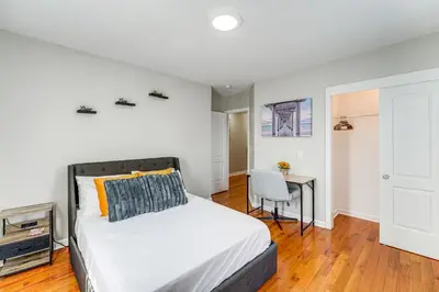 a bedroom with a bed and a desk at 2 Mi to Dtwn Well-Appointed Bridgeport Duplex! in Bridgeport