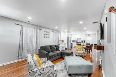 a living room with a couch and a table at 2 Mi to Dtwn Well-Appointed Bridgeport Duplex! in Bridgeport