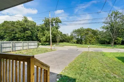 a porch with a wooden fence and a driveway at 2 Mi to Dtwn Well-Appointed Bridgeport Duplex! in Bridgeport