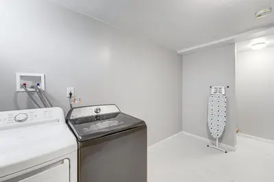 a white kitchen with a stove and a dishwasher at 2 Mi to Dtwn Well-Appointed Bridgeport Duplex! in Bridgeport