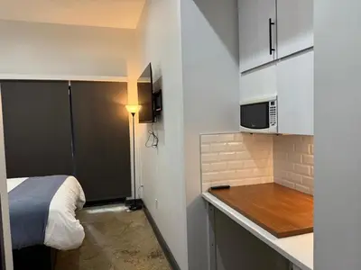 a small kitchen with a bed and a microwave at Tribeca Hotel FiDi in New York