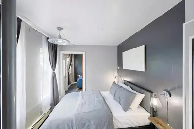 a bedroom with a white bed and a window at Lux Apt in Beacon