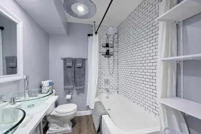 a bathroom with a tub and a toilet and a sink at Lux Apt in Beacon