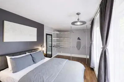 a bedroom with a large bed and a window at Lux Apt in Beacon