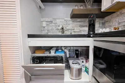 a kitchen with a sink and a dishwasher at Lux Apt in Beacon