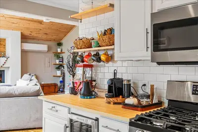a kitchen with a counter top with a stove top oven at Pocono Scandinavian Cottage cottage in Tobyhanna