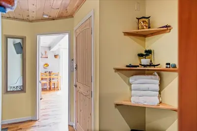a room with shelves on the wall and a hallway at Pocono Scandinavian Cottage cottage in Tobyhanna