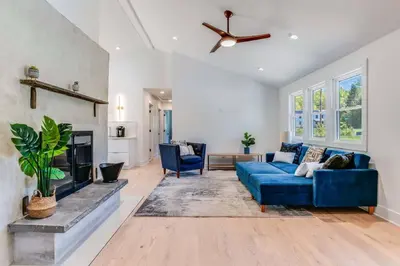 a living room with a blue couch and a fireplace at New Paltz Modern Zen Cabin in New Paltz