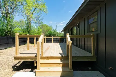 a wooden deck on the side of a house at New Paltz Modern Zen Cabin in New Paltz