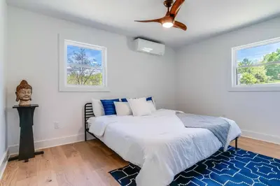 a bedroom with a bed and a ceiling fan at New Paltz Modern Zen Cabin in New Paltz