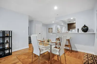 a dining room with a glass table and white chairs at The Lenox in New York