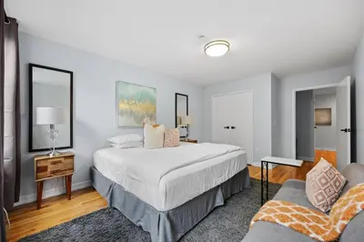 a bedroom with a large bed and a couch at The Lenox in New York