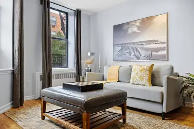 a living room with a couch and a table at The Lenox in New York