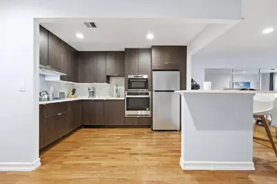 a kitchen with stainless steel appliances and wooden cabinets at The Lenox in New York